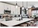 Bright kitchen features white cabinetry, stainless steel appliances, and large island with seating at 1295 Maclaren Ct, Franklin, IN 46131