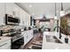 Modern kitchen features stainless appliances, white cabinets, island with seating and eat in table at 1295 Maclaren Ct, Franklin, IN 46131