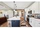 Modern kitchen with white cabinets, stainless steel appliances, and island with quartz countertops at 1295 Maclaren Ct, Franklin, IN 46131