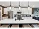 Modern kitchen features stainless steel appliances and a large island with seating at 1295 Maclaren Ct, Franklin, IN 46131