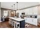 Spacious kitchen features stainless steel appliances, a large island, and white cabinetry at 1295 Maclaren Ct, Franklin, IN 46131