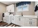 Well-equipped laundry room with modern appliances, ample countertop space, and natural light from the window at 1295 Maclaren Ct, Franklin, IN 46131