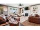 Inviting living room featuring a fireplace, built-in shelving, hardwood floors, and ample seating for relaxation at 1295 Maclaren Ct, Franklin, IN 46131
