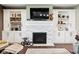 Elegant living room with a modern fireplace, built-in cabinets, and sleek hardwood flooring at 1295 Maclaren Ct, Franklin, IN 46131