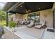 Relaxing outdoor patio featuring lounge chairs, seating area, ceiling fan, and stylish brick exterior at 1295 Maclaren Ct, Franklin, IN 46131