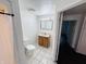Bright bathroom featuring a wood vanity, neutral wall paint and a decorative mirror with vanity lighting at 1445 S 750 W, Shelbyville, IN 46176