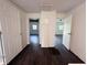 Hallway with hardwood floors leading to various rooms with white doors at 1445 S 750 W, Shelbyville, IN 46176