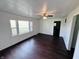 Bright living room featuring hardwood floors, a ceiling fan, and large windows at 1445 S 750 W, Shelbyville, IN 46176