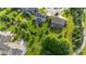 Landscaped backyard featuring a deck, patio, and an abundance of lush greenery at 15047 Glenmoor Cir, Carmel, IN 46033