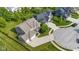 Expansive home with a well-manicured yard, mature trees, and an extended driveway at 15047 Glenmoor Cir, Carmel, IN 46033