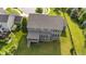 Backyard featuring a covered porch, well-maintained lawn, and mature landscaping at 15047 Glenmoor Cir, Carmel, IN 46033