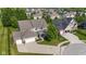 Beautiful home featuring a three-car garage, manicured lawn, and lush landscaping at 15047 Glenmoor Cir, Carmel, IN 46033
