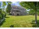 Serene backyard setting with mature trees and well-manicured lawn, providing a private retreat at 15047 Glenmoor Cir, Carmel, IN 46033