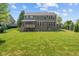 Spacious backyard featuring a well-maintained lawn and a screened-in porch, ideal for outdoor gatherings at 15047 Glenmoor Cir, Carmel, IN 46033