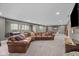 Finished basement featuring a large, comfortable leather couch and recreational game tables at 15047 Glenmoor Cir, Carmel, IN 46033