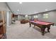 Spacious finished basement with pool table, lounge area, and recreational game tables at 15047 Glenmoor Cir, Carmel, IN 46033
