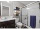 Bright bathroom with a modern vanity, shelving, and glass-enclosed shower at 15047 Glenmoor Cir, Carmel, IN 46033