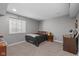 Cozy bedroom with neutral colors, natural light, and practical furnishings at 15047 Glenmoor Cir, Carmel, IN 46033