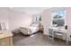 This cozy bedroom offers plenty of natural light, neutral tones, and carpeted floors at 15047 Glenmoor Cir, Carmel, IN 46033