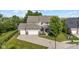 Stately two-story home with a three-car garage and manicured landscaping at 15047 Glenmoor Cir, Carmel, IN 46033