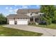 Charming home featuring a three-car garage, brick accents, and well-manicured lawn at 15047 Glenmoor Cir, Carmel, IN 46033