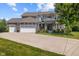 Charming two-story home boasts a three-car garage, a brick facade, and a beautifully landscaped front yard at 15047 Glenmoor Cir, Carmel, IN 46033
