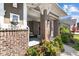 Close up of home's front entrance with brick columns, decorative wreath, and manicured flowerbeds at 15047 Glenmoor Cir, Carmel, IN 46033