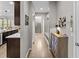 Hallway featuring hardwood floors, neutral walls, and stylish decorative furniture at 15047 Glenmoor Cir, Carmel, IN 46033