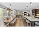 Spacious dining area adjacent to a modern kitchen with a large island and stylish lighting at 15047 Glenmoor Cir, Carmel, IN 46033