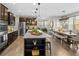 Open-concept kitchen with stainless steel appliances, a large island, and modern pendant lighting at 15047 Glenmoor Cir, Carmel, IN 46033