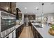 Modern kitchen with stainless steel appliances, white countertops, and stylish backsplash at 15047 Glenmoor Cir, Carmel, IN 46033