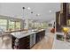 Spacious kitchen island with a sink and seating that opens to the dining and living areas at 15047 Glenmoor Cir, Carmel, IN 46033