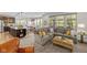Spacious living room with open layout, kitchen, modern decor, and large windows at 15047 Glenmoor Cir, Carmel, IN 46033