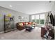 Bright living room with a comfortable brown sofa, decorative pillows, and lots of natural light at 15047 Glenmoor Cir, Carmel, IN 46033
