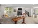Open-concept living room featuring a fireplace, large windows, and comfortable seating at 15047 Glenmoor Cir, Carmel, IN 46033