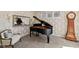 Elegant music room with a grand piano, decorative wallpaper, and natural light at 15047 Glenmoor Cir, Carmel, IN 46033