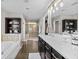 Well-lit main bathroom with a large vanity, soaking tub, and glass-enclosed shower, providing a spa-like experience at 15047 Glenmoor Cir, Carmel, IN 46033