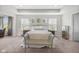 Bright main bedroom with tray ceilings, plenty of natural light, and modern décor at 15047 Glenmoor Cir, Carmel, IN 46033