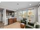 Cozy sitting area with armchairs, a decorative cabinet, and large windows at 15047 Glenmoor Cir, Carmel, IN 46033