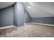 An attic featuring neutral walls and carpet flooring, offering a versatile space at 1529 E Tabor St, Indianapolis, IN 46203