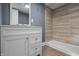 This bathroom has a tiled shower, a vanity with storage, and a mirror at 1529 E Tabor St, Indianapolis, IN 46203