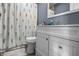 Bathroom with white vanity, neutral walls and a shower with decorative curtain at 1529 E Tabor St, Indianapolis, IN 46203