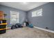 Spacious bedroom with neutral walls, carpet flooring, and a window for natural light at 1529 E Tabor St, Indianapolis, IN 46203