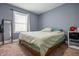 This bedroom features carpet flooring, a window for natural light, and neutral wall paint at 1529 E Tabor St, Indianapolis, IN 46203