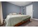 This bedroom features carpet flooring, a window for natural light, and neutral wall paint at 1529 E Tabor St, Indianapolis, IN 46203