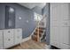 View of the stairway featuring carpeted steps, a railing, and a nearby storage cabinet at 1529 E Tabor St, Indianapolis, IN 46203