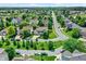 Aerial view showcases a charming residential neighborhood with winding streets, mature trees, and well-maintained homes at 16138 Palmyra Green, Westfield, IN 46074