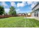 Expansive backyard with lush green grass and a privacy fence, ideal for outdoor activities at 16138 Palmyra Green, Westfield, IN 46074