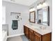 Bathroom with double sinks, a large vanity, framed mirrors, and modern lighting fixtures at 16138 Palmyra Green, Westfield, IN 46074