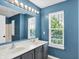Bathroom with double sinks, a large mirror, and modern vanity lighting at 16138 Palmyra Green, Westfield, IN 46074